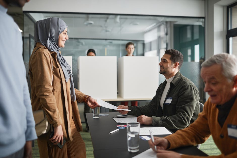 A diverse group of adults participating in voting at an indoor polling station.